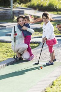 Family playing mini golf at Holywell Bay golf